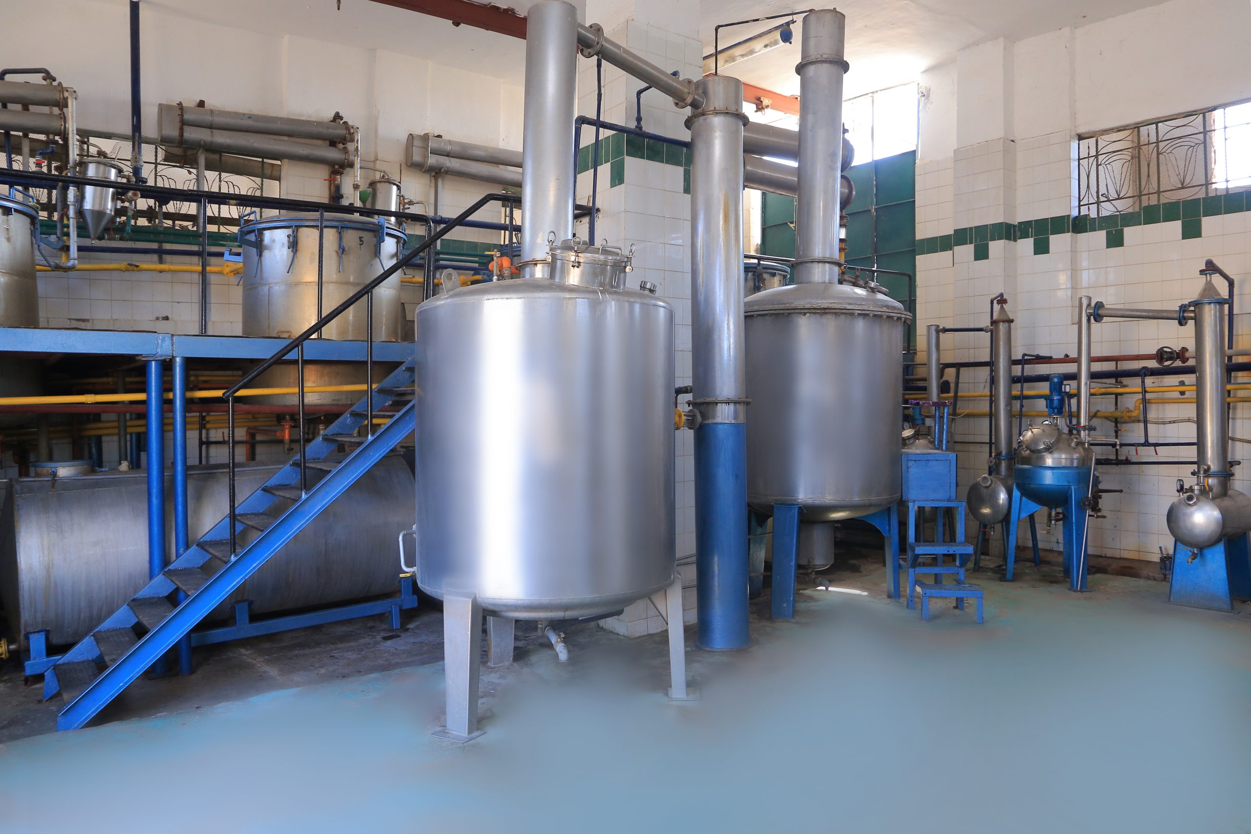 Wide view of PHATRADE's distillation hall with stainless steel columns and condensers