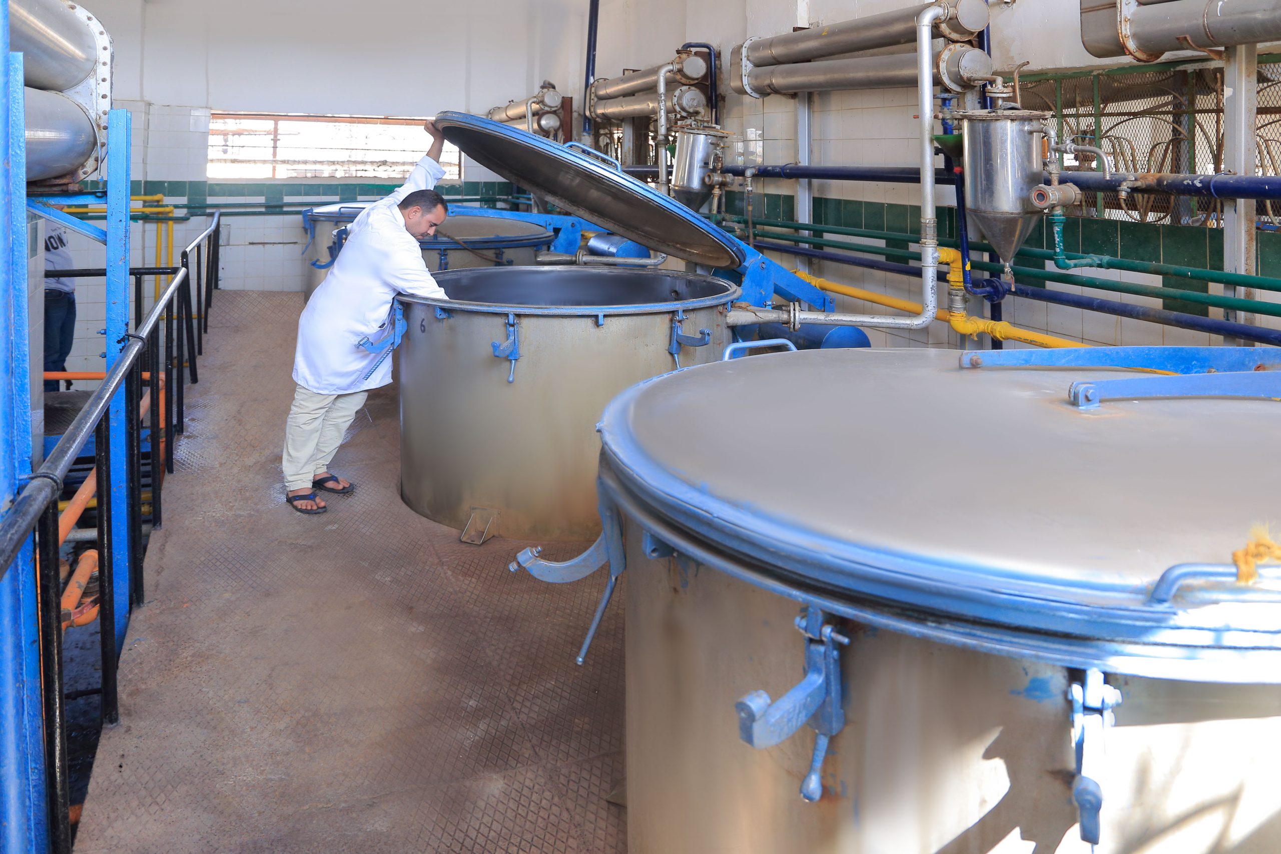 PHATRADE technician in full PPE inspecting a reactor vessel during production